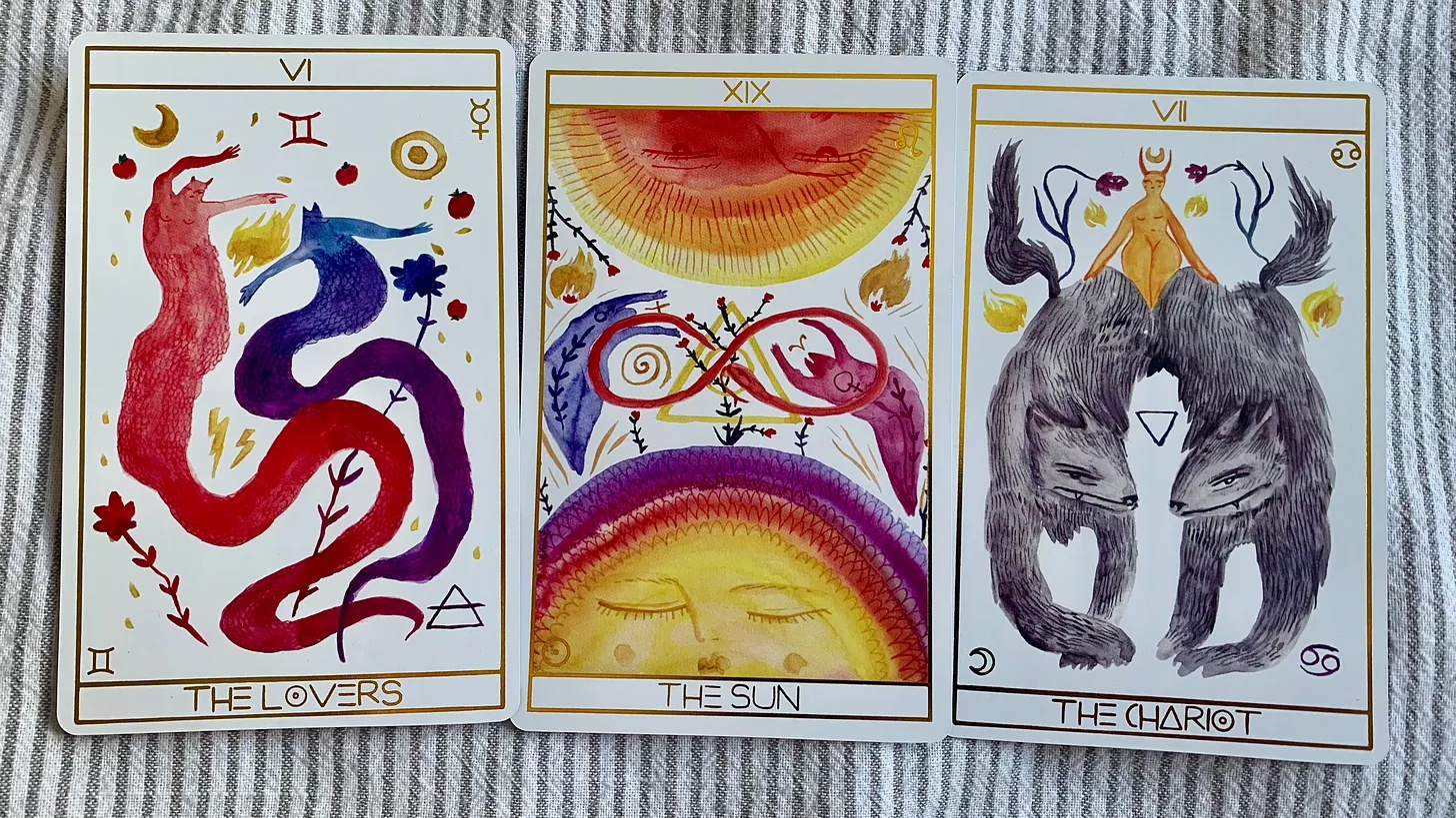 Three tarot cards from the Lilifer Tarot deck, from left to right: The Lovers, The Sun, The Chariot